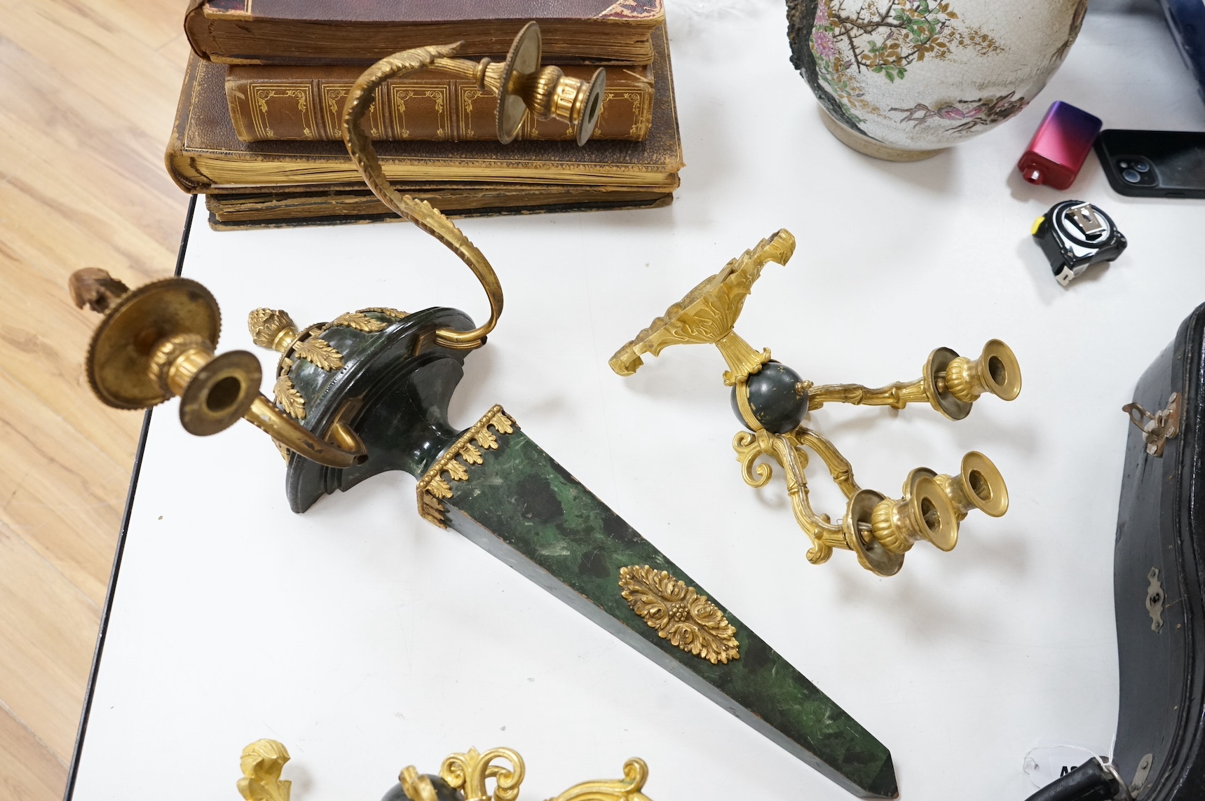 A simulated malachite wall sconce and a pair of ormolu three-branch wall lights, 55cm high. Condition - fair/good